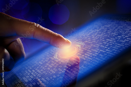 Photo: Closeup of finger touching tablet-pc screen Closeup of finger touching tablet-pc screen