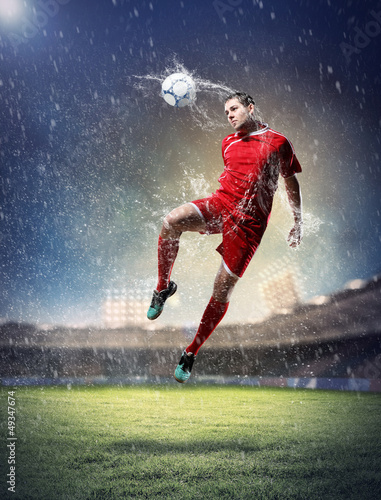 Photo: football player striking the ball football player striking the ball