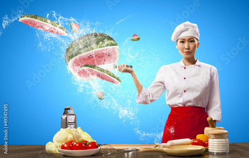 Photo: Asian female cook with knife Asian female cook with knife