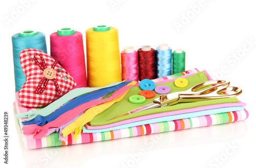 Photo: Sewing accessories and fabric isolated on white Sewing accessories and fabric isolated on white