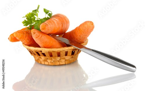 Photo: carrots with knife in basket isolated on white carrots with knife in basket isolated on white