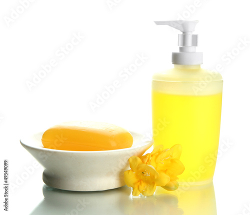 Photo: Bottle and soap-dish with soap isolated on white Bottle and soap-dish with soap isolated on white