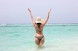 young woman in sea with open hands