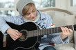 A boy playing guitar