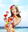 Woman in hawaii costume drink  juice.
