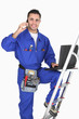 Electrician posing with his building materials and tools
