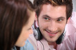 young man and woman listening music at home