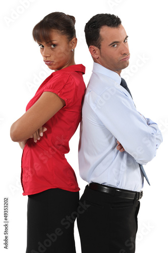 Photo: couple standing back to back after quarrel couple standing back to back after quarrel