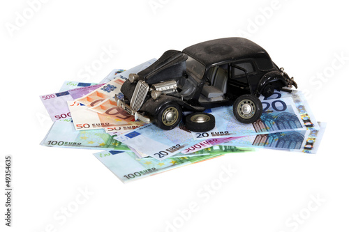 Photo: Model of an old car on a pile of banknotes Model of an old car on a pile of banknotes