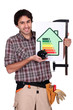 Man holding up an energy efficiency rating sign