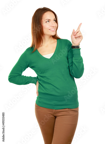 Photo: Woman pointing up at copy space over white background Woman pointing up at copy space over white background