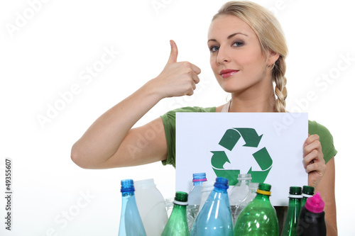 Photo: Woman stood with crate of empty plastic bottles Woman stood with crate of empty plastic bottles