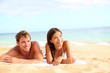 Couple on beach looking happy