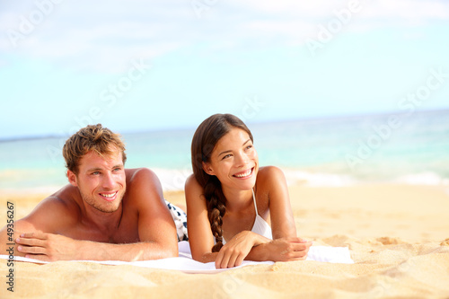 Photo: Couple on beach looking happy Couple on beach looking happy