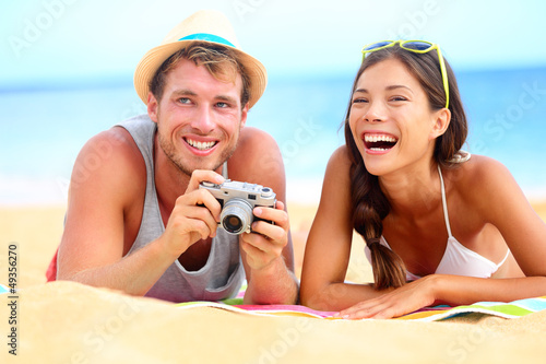 Photo: Young happy multicultural couple on beach Young happy multicultural couple on beach