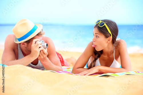 Photo: Young couple having fun on beach Young couple having fun on beach