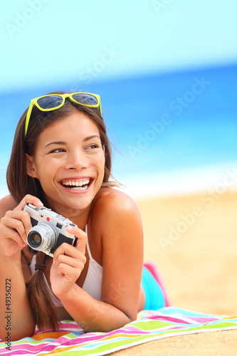 Photo: Summer beach woman fun holding camera Summer beach woman fun holding camera