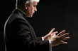 Closeup portrait of male orchestra conductor directing with his