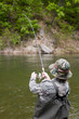Fisherman pulls caught salmon
