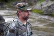 Photo: Backpacker standing a mountain river Backpacker standing a mountain river