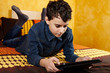 Young boy studying on digital tablet