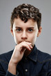 Smart-looking young boy pondering