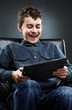 Cheerful child playing on tablet