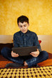 Young boy reading on digital tablet