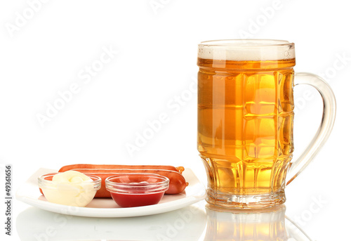 Photo: Beer and grilled sausages isolated on white Beer and grilled sausages isolated on white