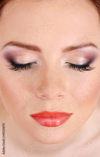 Photo: Beautiful female face with bright make-up, close up Beautiful female face with bright make-up, close up