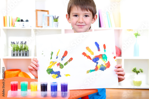 Photo: Cute little boy with his colorful handprint Cute little boy with his colorful handprint
