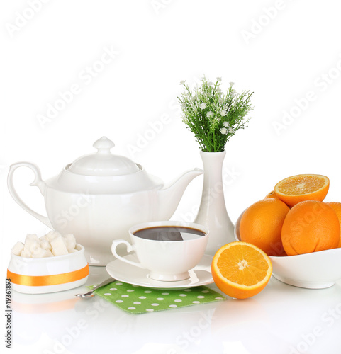 Photo: Beautiful white dinner service with oranges isolated on white Beautiful white dinner service with oranges isolated on white