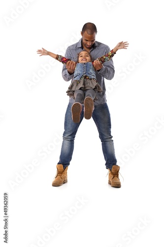 Photo: Ethnic man playing with little daughter having fun Ethnic man playing with little daughter having fun