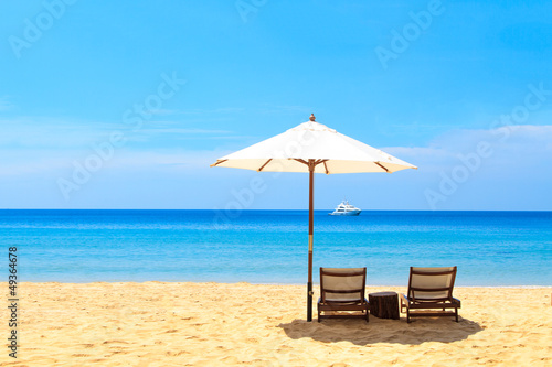 Photo: beds and umbrella on a beach beds and umbrella on a beach