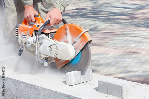 Photo: Cutting and grinding concrete or metal using a cut off saw Cutting and grinding concrete or metal using a cut off saw