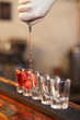 bartender fills a few glasses in a row