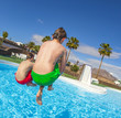 boy  jumping in the blue pool