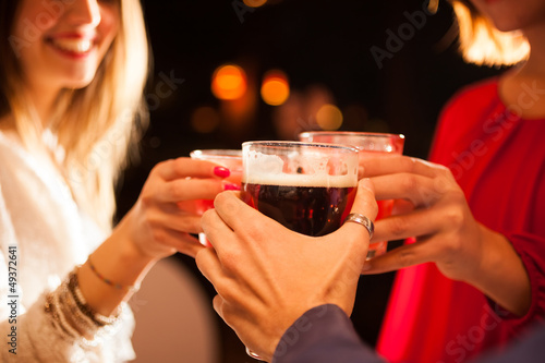 Photo: Friends having a round of drinks Friends having a round of drinks