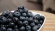 Rotating Blueberries in a bowl on a wooden plate