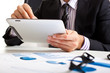 Photo: Businessman using a tablet during a business meeting Businessman using a tablet during a business meeting