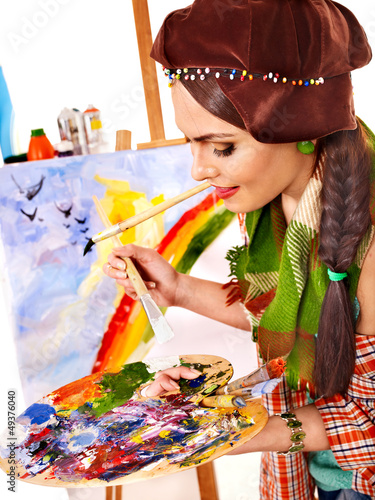 Photo: Female artist at work. Female artist at work.