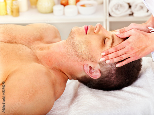 Photo: Man getting facial massage . Man getting facial massage .