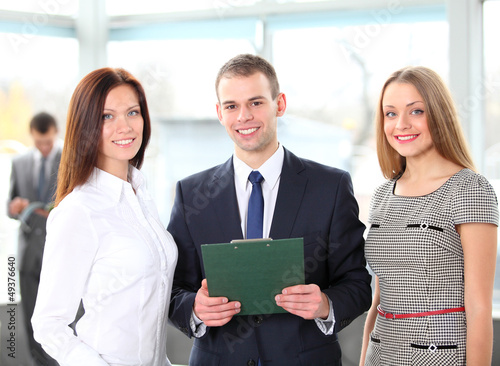 Photo: Happy business team discussing together their business strategy Happy business team discussing together their business strategy