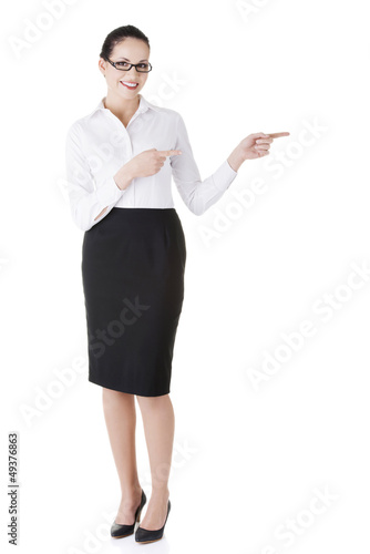 Photo: Happy young business woman showing copy space Happy young business woman showing copy space