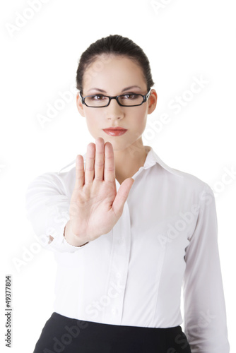 Photo: Serious businesswoman gesturing stop Serious businesswoman gesturing stop