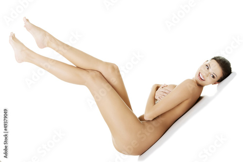 Photo: Sexy fit naked woman lying down Sexy fit naked woman lying down