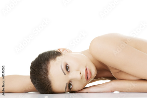 Photo: Sexy fit naked woman lying down Sexy fit naked woman lying down