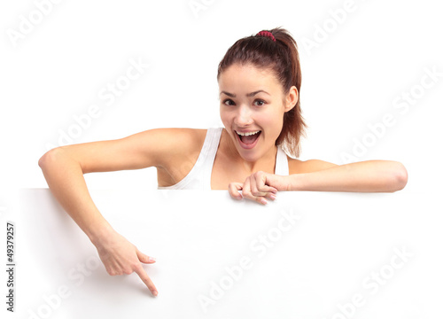 Photo: Happy smiling young business woman showing blank signboard Happy smiling young business woman showing blank signboard