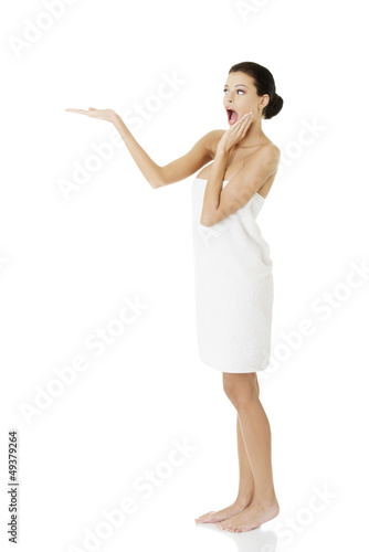 Photo: Happy woman in towel showing copy space Happy woman in towel showing copy space