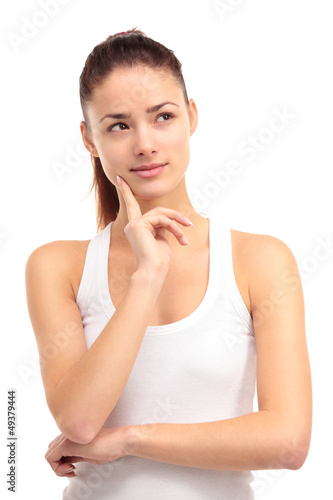 Photo: A pretty young woman gazing into the distance on a white A pretty young woman gazing into the distance on a white